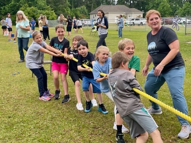 Wanchese Christian Academy students and families taking part in an outdoor school activity.