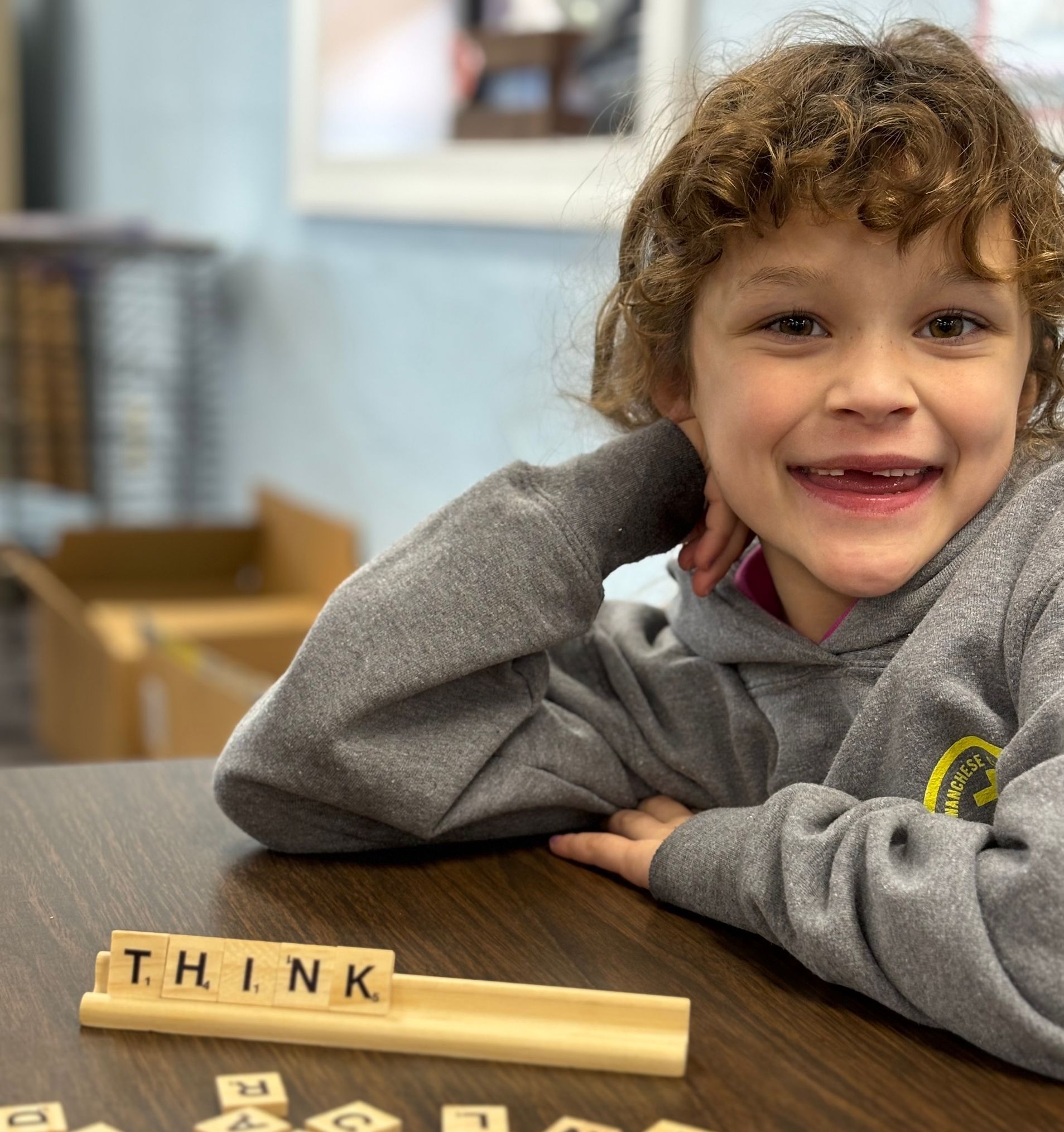 A Wanchese Christian Academy student working at a classroom table.